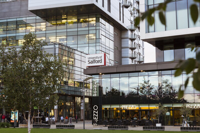 The University of Salford Media City Campus. Impressive glass buildings set in a park.