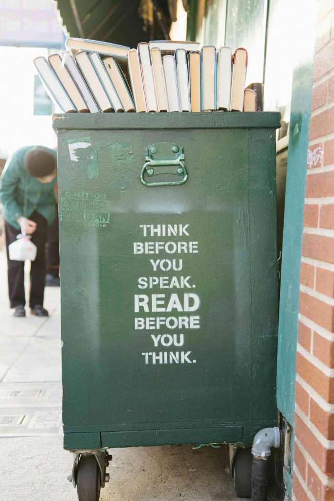 A street bin printed with the words: "Think before you speak. Read before you think."