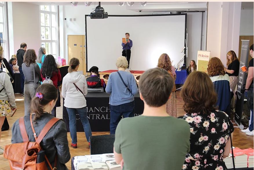 People listening to a speaker at The Northern Publishers Fair.